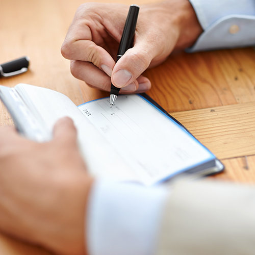 image of person writing in check book